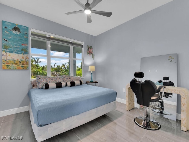 bedroom with a ceiling fan and baseboards