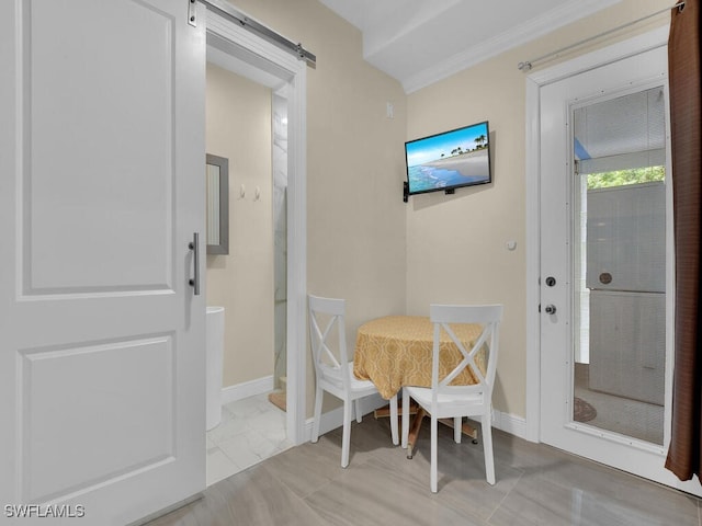 dining area featuring ornamental molding, marble finish floor, a barn door, and baseboards