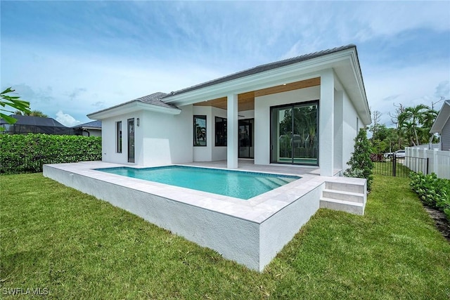 rear view of property with a fenced in pool, stucco siding, a yard, and fence