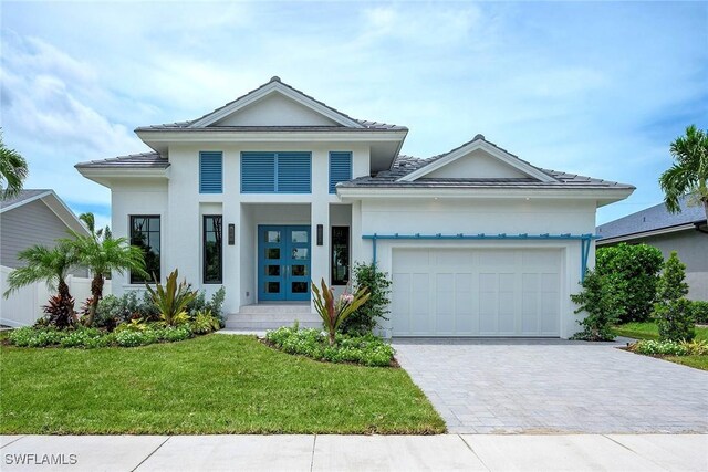 view of front of home featuring a garage, a front yard, and french doors