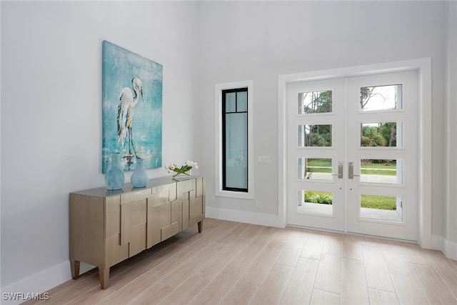 doorway to outside featuring light hardwood / wood-style flooring and french doors