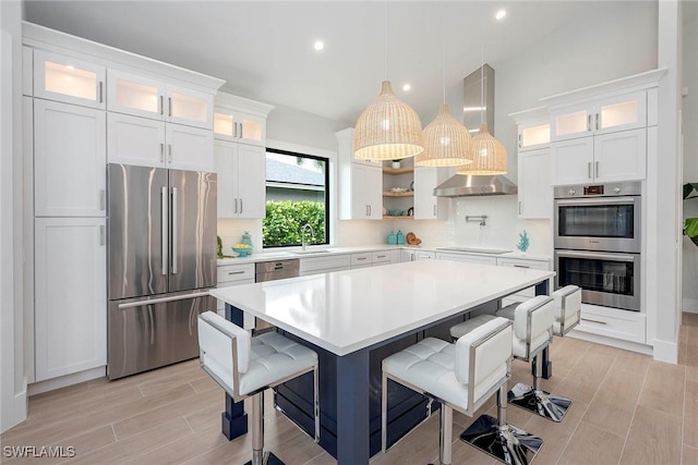 kitchen with light countertops, wood finish floors, backsplash, and stainless steel appliances