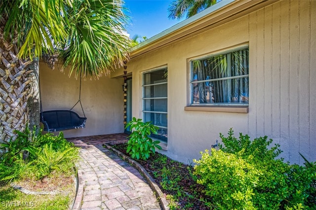 entrance to property featuring stucco siding