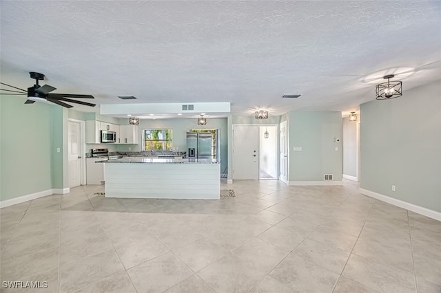 kitchen featuring ceiling fan, light tile patterned flooring, stainless steel appliances, and white cabinetry