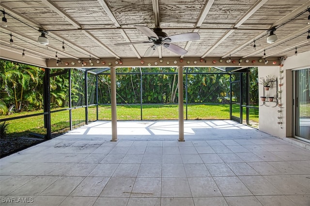 unfurnished sunroom with ceiling fan