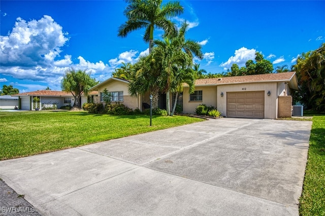 single story home featuring a front lawn, central air condition unit, and a garage