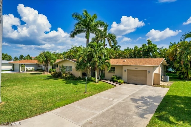 view of front of house with a garage, central air condition unit, and a front lawn