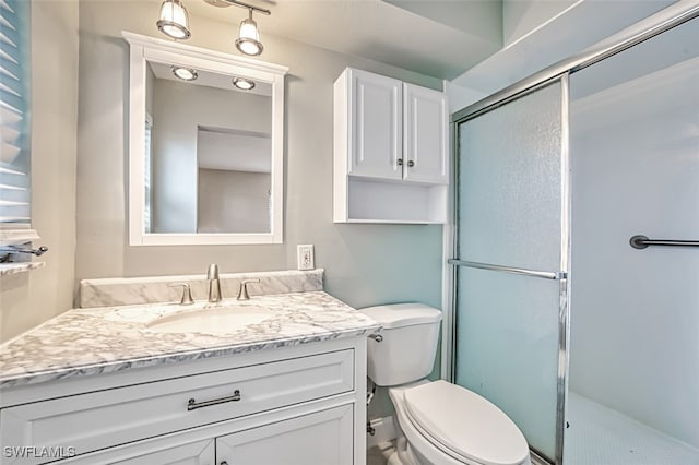 bathroom featuring walk in shower, vanity, and toilet