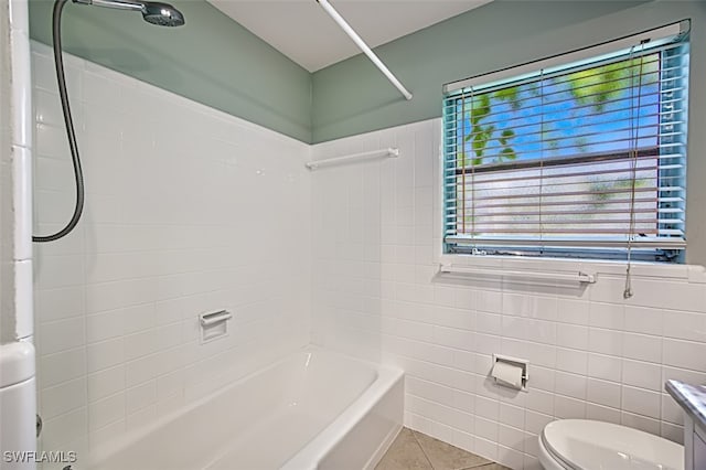 full bath with toilet, vanity, tile walls, tub / shower combination, and tile patterned floors