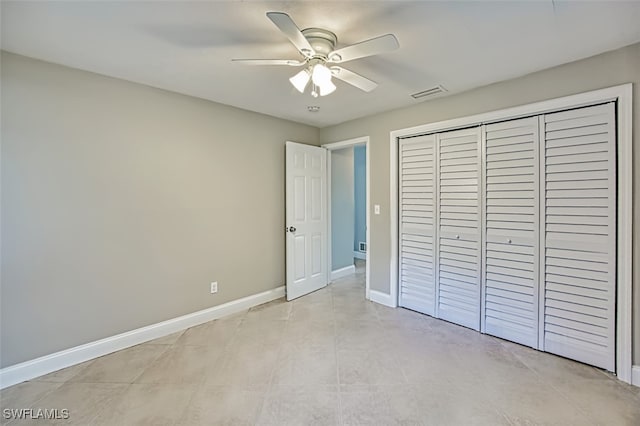 unfurnished bedroom with ceiling fan, a closet, visible vents, and baseboards