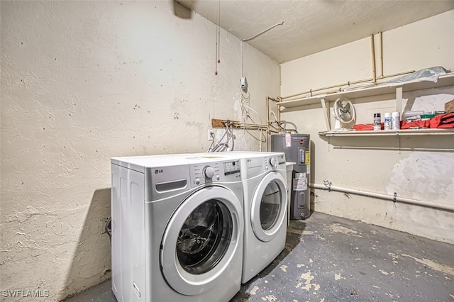 laundry room featuring water heater, a textured ceiling, and washing machine and clothes dryer