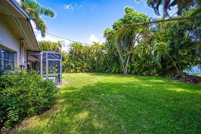 view of yard featuring glass enclosure