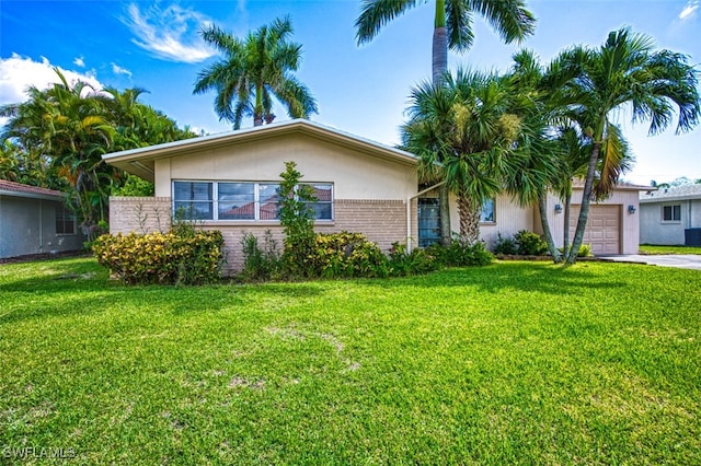 ranch-style house featuring driveway, a front lawn, an attached garage, and stucco siding