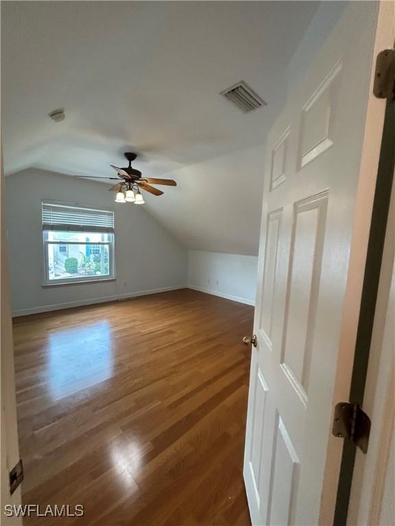 interior space with ceiling fan, lofted ceiling, and hardwood / wood-style flooring