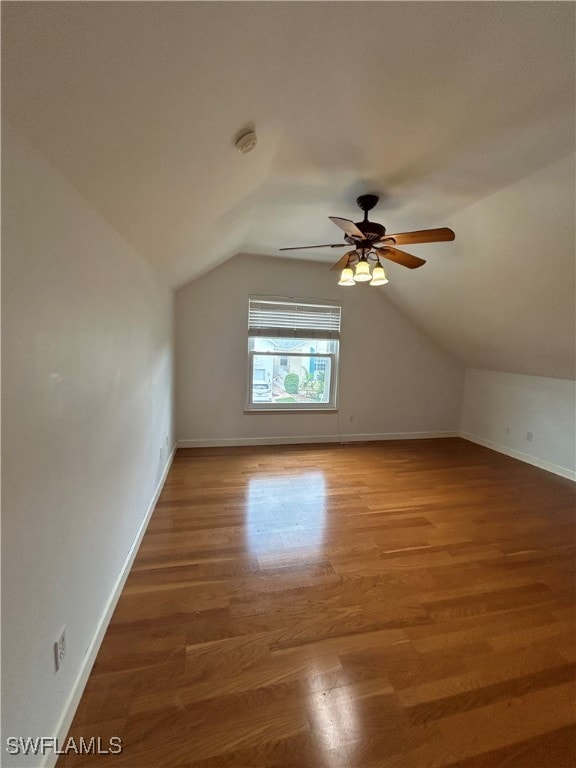 additional living space with lofted ceiling, wood-type flooring, and ceiling fan