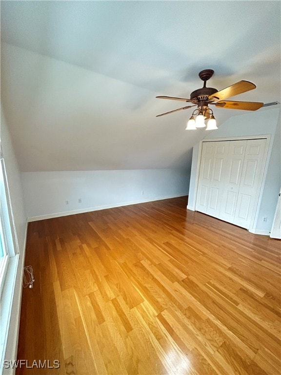 interior space with ceiling fan, vaulted ceiling, and light hardwood / wood-style floors