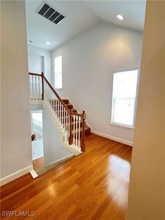 stairway featuring wood-type flooring