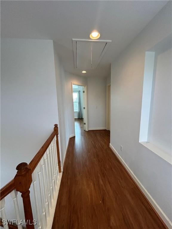 corridor featuring recessed lighting, wood finished floors, an upstairs landing, baseboards, and attic access