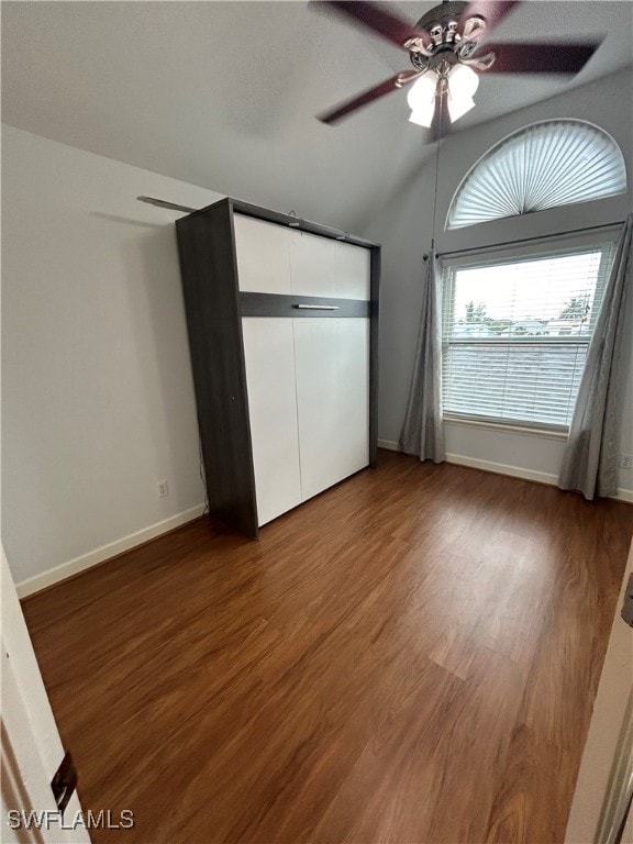 unfurnished bedroom with ceiling fan, lofted ceiling, hardwood / wood-style flooring, and a closet