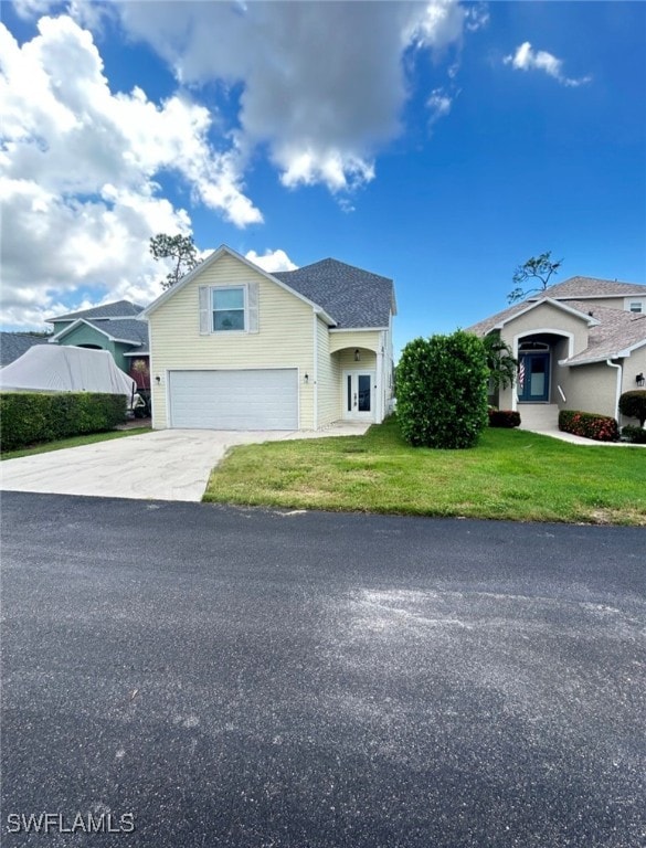 view of front of home featuring a front yard and a garage