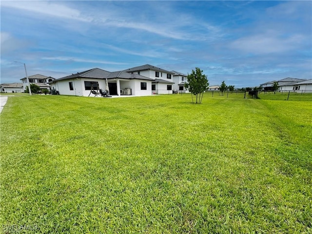 view of yard featuring fence and a patio