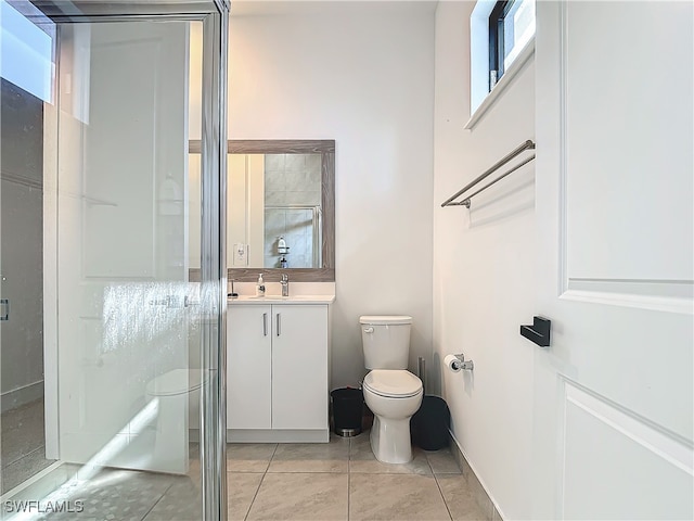 bathroom with a stall shower, tile patterned flooring, vanity, and toilet