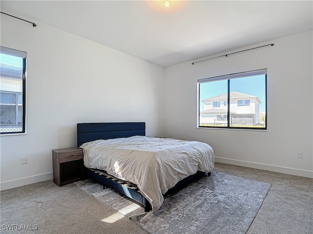 carpeted bedroom featuring baseboards