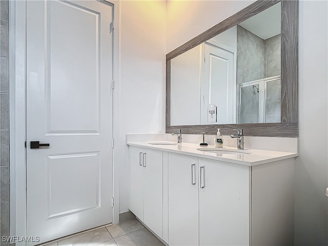 bathroom featuring vanity, tile patterned floors, and a shower with shower door