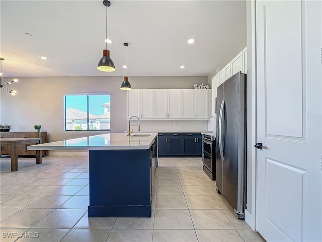 kitchen featuring stainless steel fridge, blue cabinets, light countertops, white cabinetry, and a sink