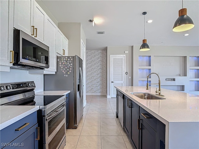 kitchen featuring sink, stainless steel appliances, white cabinets, decorative light fixtures, and light tile patterned flooring