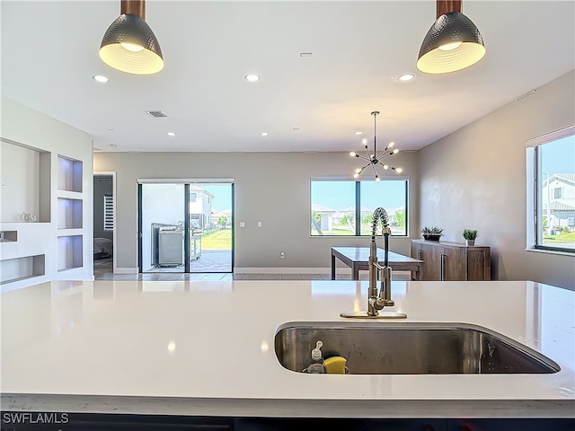 kitchen featuring hanging light fixtures, a healthy amount of sunlight, and sink