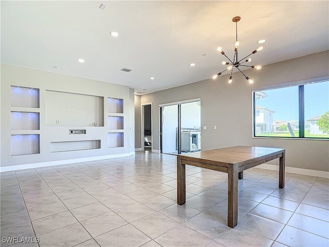 interior space with built in shelves, light tile patterned floors, visible vents, an inviting chandelier, and baseboards