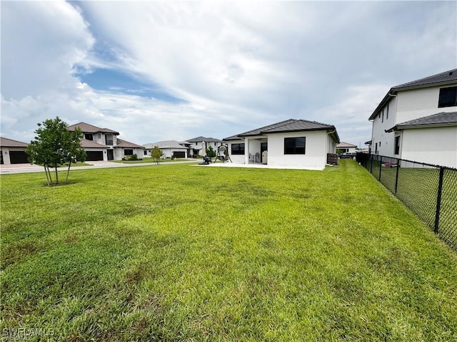 view of yard with a residential view and fence