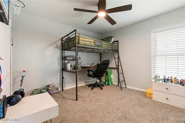 bedroom featuring ceiling fan, multiple windows, and carpet