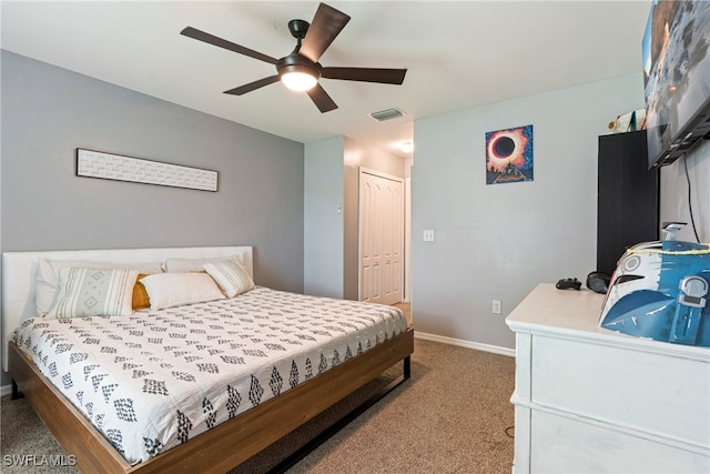 bedroom with ceiling fan, light carpet, and a closet