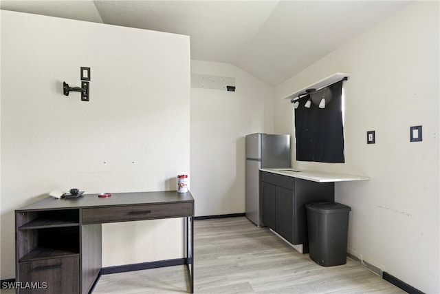 interior space with lofted ceiling and light hardwood / wood-style floors