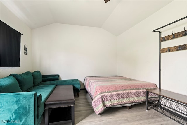 bedroom featuring vaulted ceiling and hardwood / wood-style floors