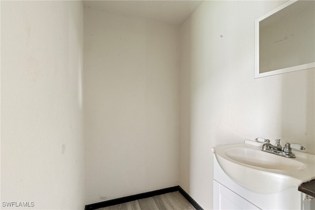 bathroom with vanity and hardwood / wood-style floors