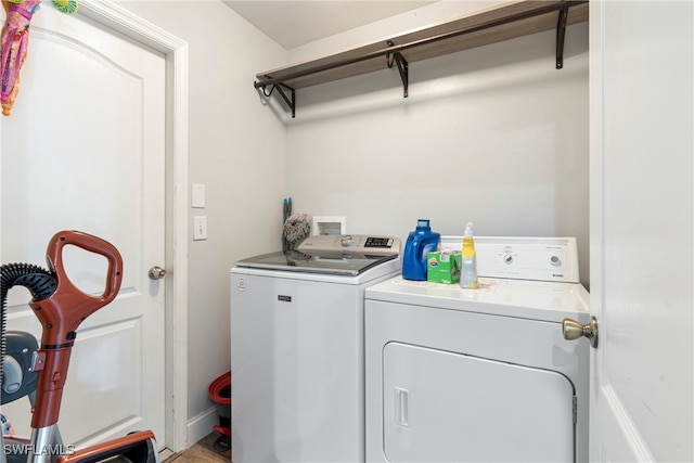 clothes washing area featuring independent washer and dryer