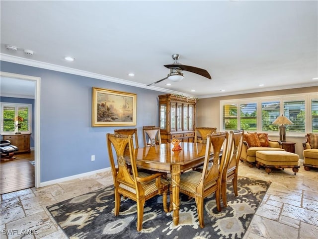 dining area with crown molding and ceiling fan