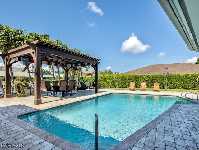 view of swimming pool featuring a pergola and a patio area