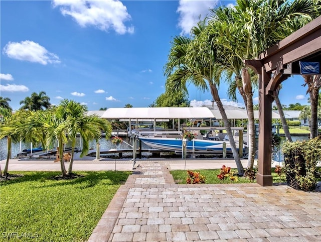 dock area with a lawn and a water view