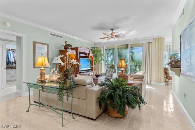 tiled living room featuring ornamental molding and ceiling fan