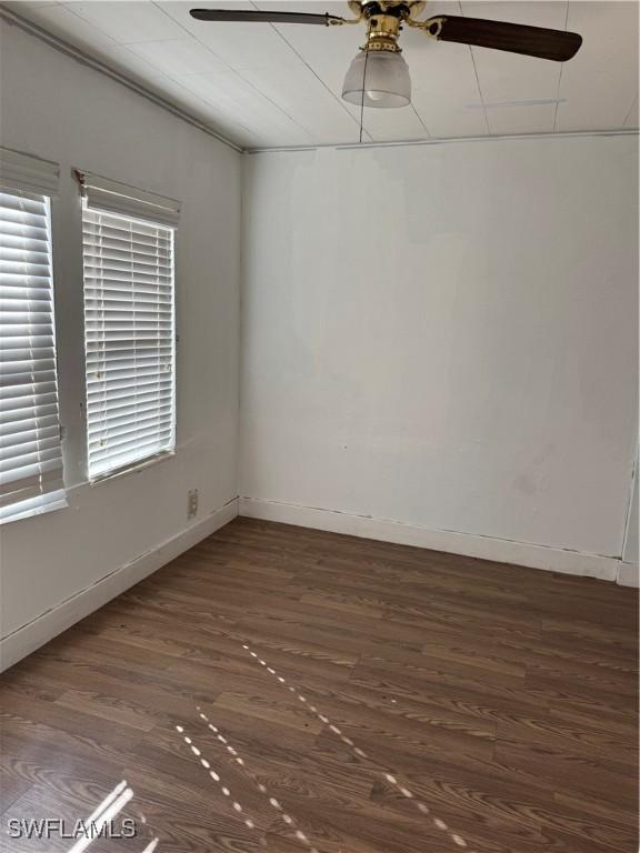 spare room with ceiling fan and dark hardwood / wood-style flooring