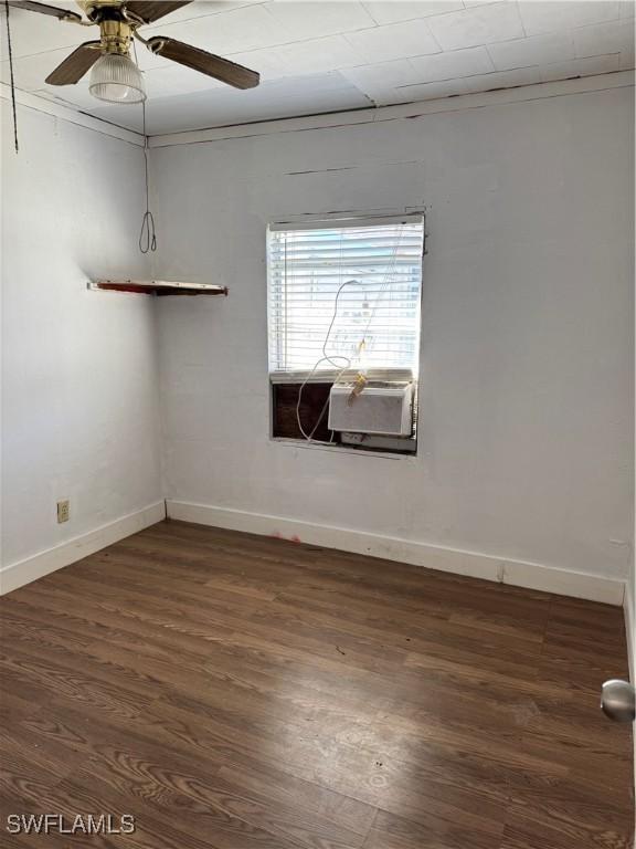 empty room featuring dark hardwood / wood-style floors, ceiling fan, and ornamental molding