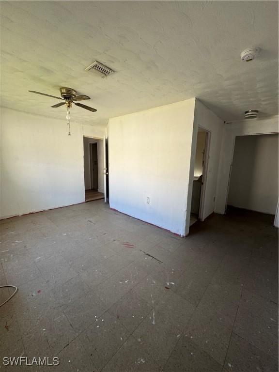 unfurnished room with ceiling fan