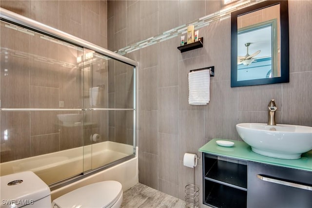 full bathroom with vanity, shower / bath combination with glass door, and toilet