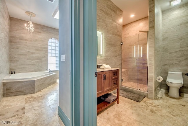 full bathroom with tile walls, vanity, shower with separate bathtub, and toilet