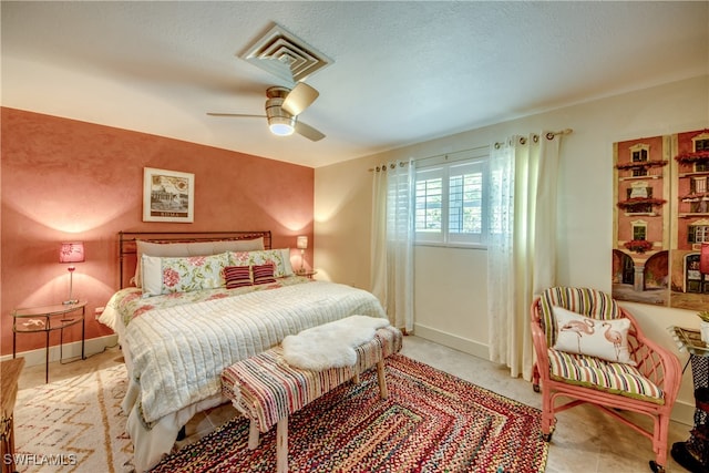 bedroom with a textured ceiling and ceiling fan