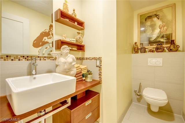 bathroom featuring tile patterned flooring, toilet, decorative backsplash, and vanity